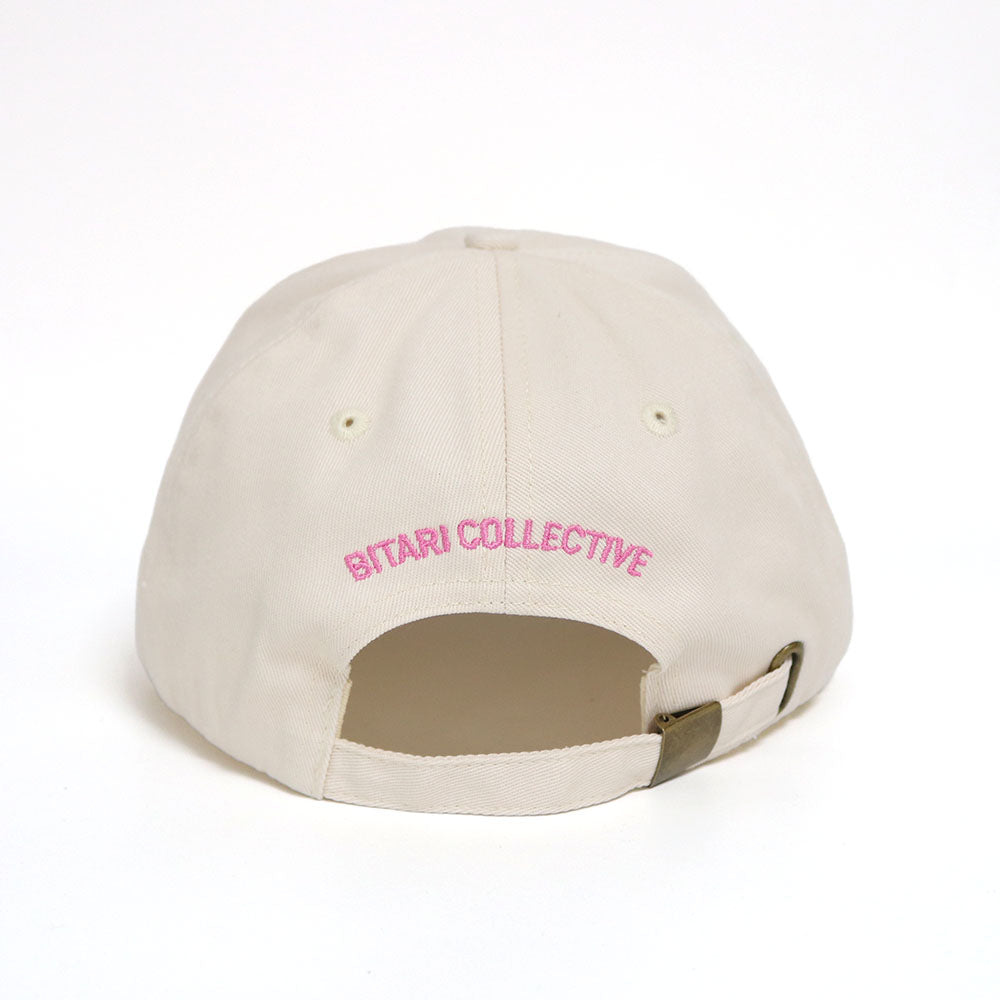 The back of an off-white dad hat with the Bitari Collective logo embroidered. 