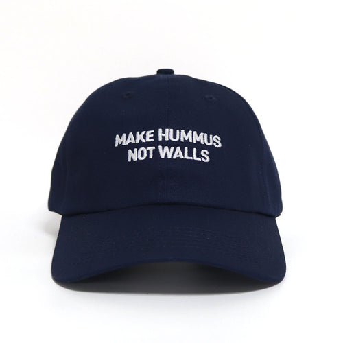 Blue dad hat with with the text 'make hummus not walls' embroidered in white.
